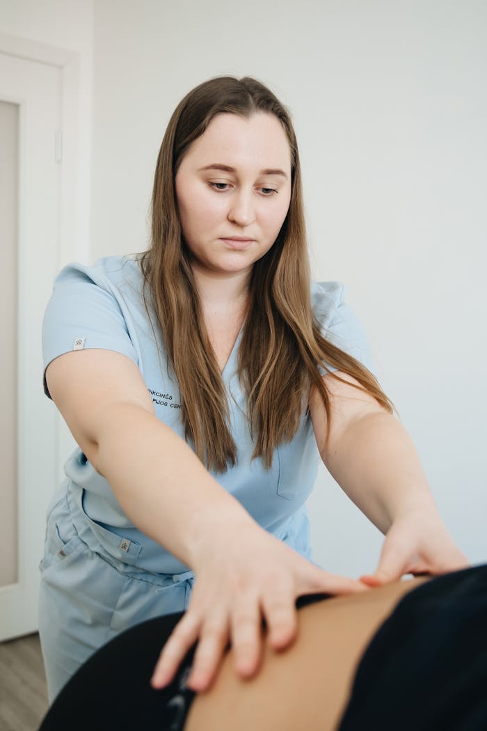 Female physiotherapist performing a therapeutic massage in a wellness clinic.
